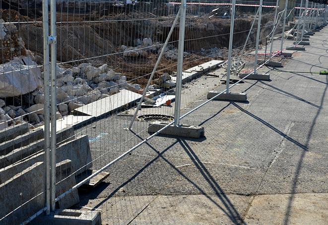 temporary fence panels used to enclose a parking lot during maintenance